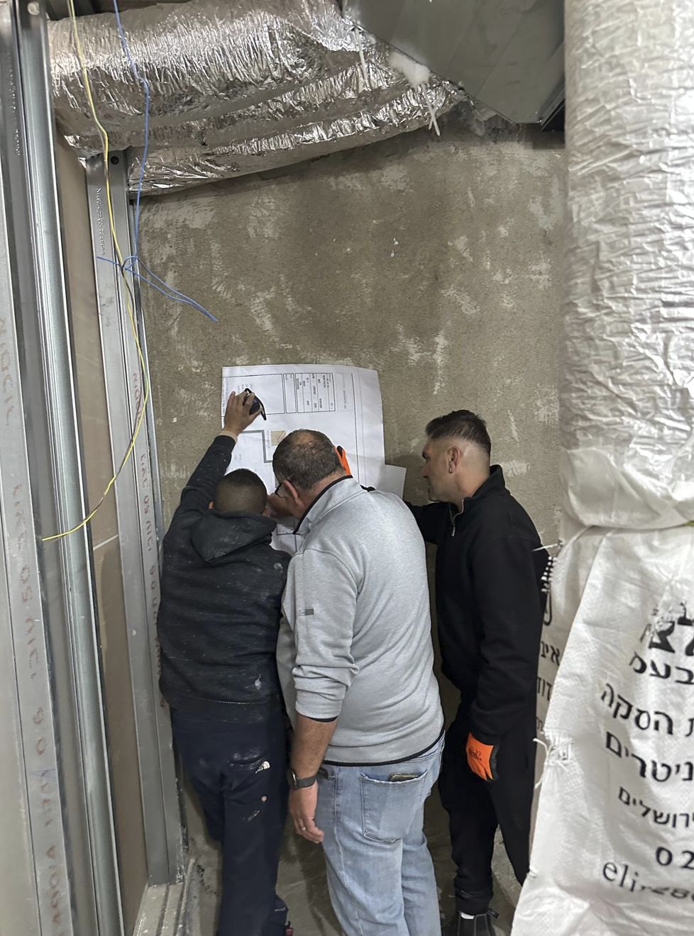Reviewing plans on site with the team