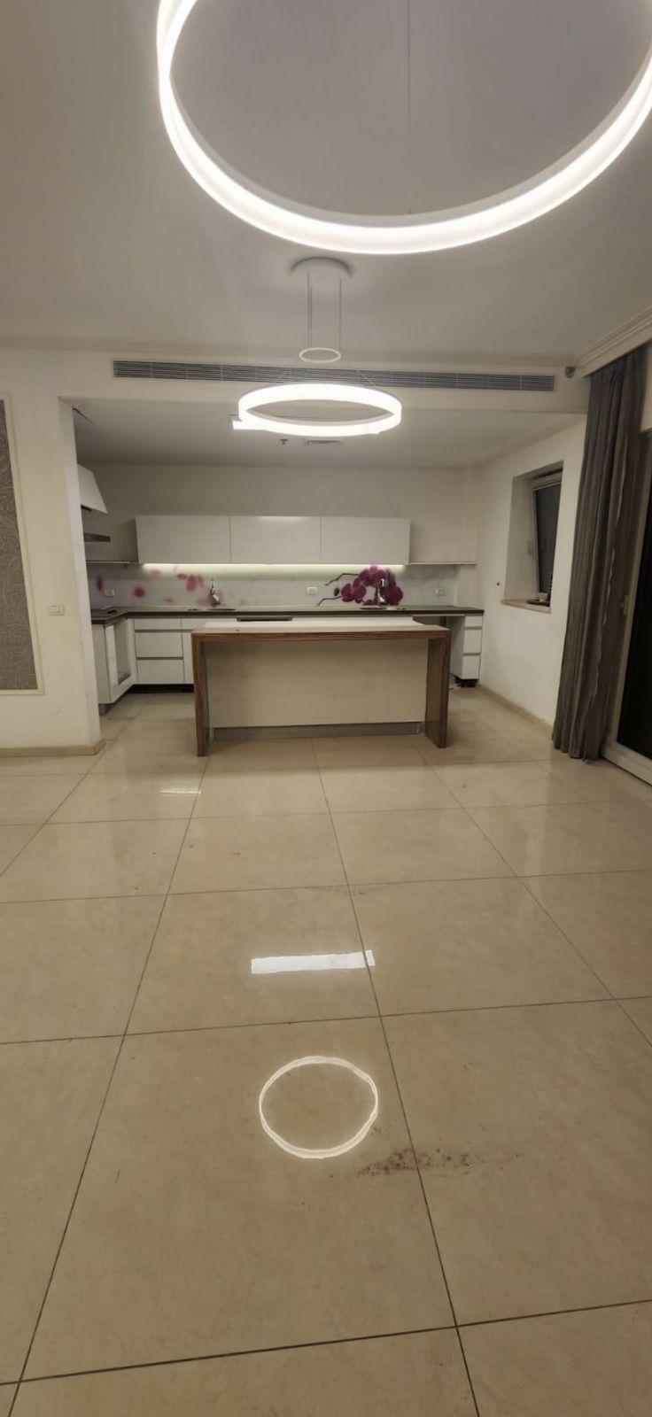 Living room with floor-to-ceiling balcony doors before renovation