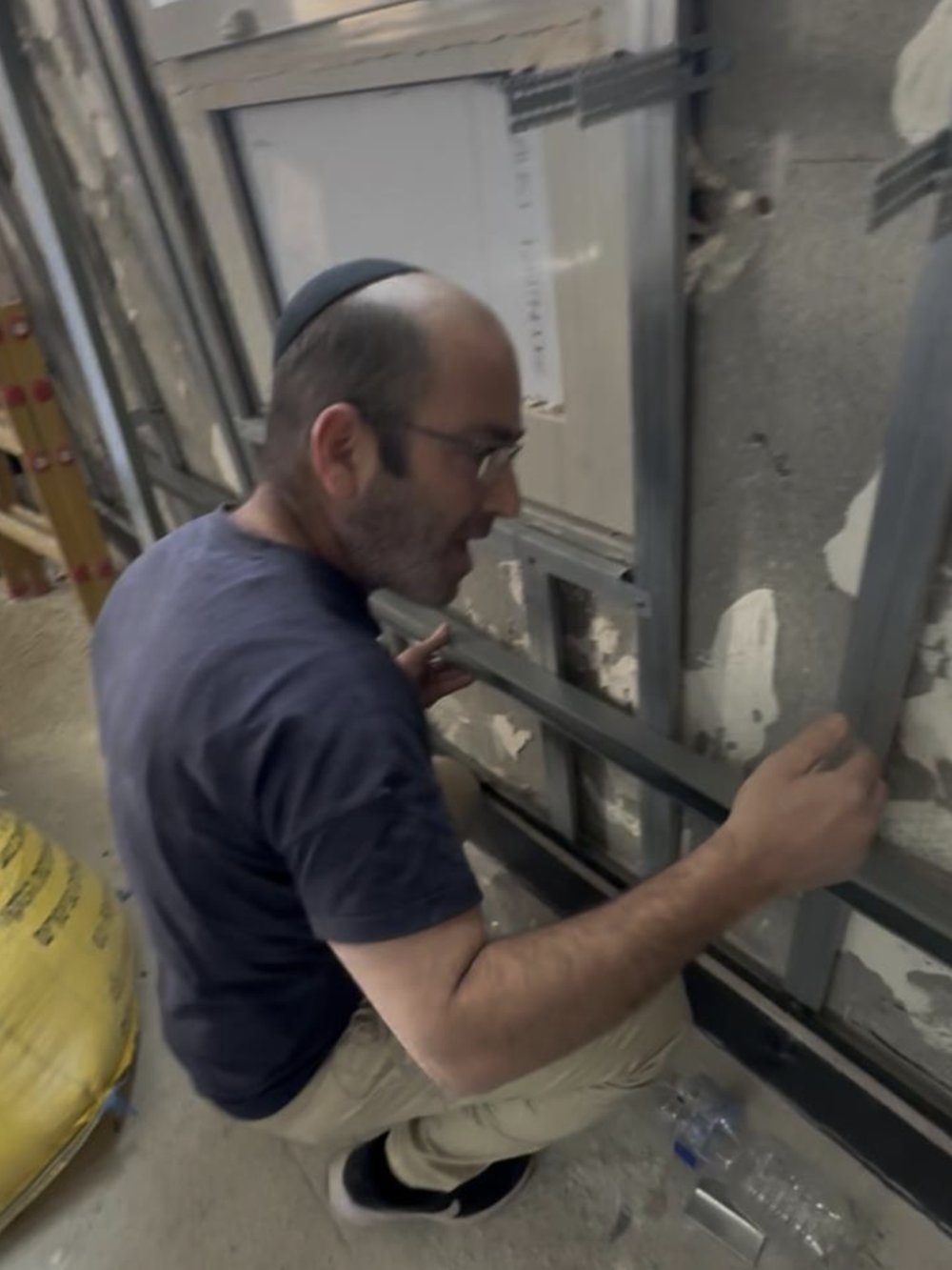 Installer fitting a door frame during a renovation